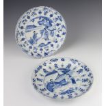 Two 18th Century Chinese shallow dishes decorated with figures in a garden landscape surrounded by