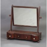 A 19th Century rectangular plate dressing table mirror contained in a mahogany swing frame, the base