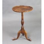 A Georgian style circular mahogany wine table raised on pillar and tripod base with hoof feet 66cm h