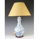 A Georgian design blue and white baluster table lamp decorated with figures in a European garden