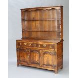 A Georgian style oak dresser, the raised back fitted 2 shelves above recess, the base with 2 long