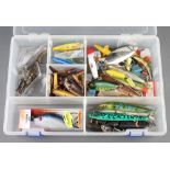 A collection of vintage and modern pike fishing lures contained within a plastic case