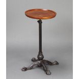A Victorian wrought iron and turned mahogany dish top adjustable wine table raised on an iron
