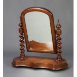 A Victorian arched plate dressing table mirror contained in a mahogany swing frame raised on