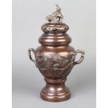 A 19th Century Japanese bronze and enamelled urn and cover with dog of fo finial, decorated birds