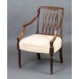 A Georgian style mahogany open armchair with trellis work back, raised on turned and fluted supports