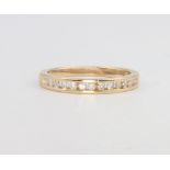 An 18ct yellow gold half eternity ring, size O 1/2, 2.8 grams