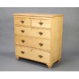 A Victorian pine chest of 2 short and 3 long drawers with brass swan neck drop handles, raised on