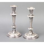 A pair of silver plated tapered candlesticks 24cm