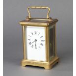 A 19th Century French carriage timepiece with enamelled dial and Roman numerals contained in a