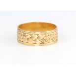 A 22ct yellow gold engraved wedding band, size L 1/2, 4.1 grams