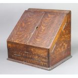 A Victorian wedge shaped oak stationery box with stepped fitted interior complete with cardboard