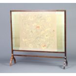 An Edwardian rectangular mahogany fire screen with floral stitch work panel 91cm h x 95cm w x 22cm d