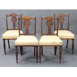 A set of 4 Victorian inlaid rosewood slat back dining chairs with pierced heart shaped slat backs
