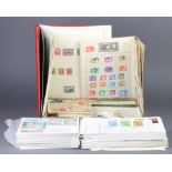 A red album of Elizabeth II mint and used GB stamps, a universal album of postage stamps, loose
