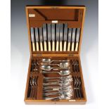 An oak canteen containing a canteen of plated cutlery for 6