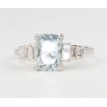 A platinum aquamarine and diamond ring, the emerald cut stone approx. 2.1ct flanked by 3 diamonds,