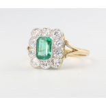 An 18ct yellow gold emerald and diamond cluster ring, the centre stone approx. 0.9ct surrounded by