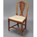 A 19th Century country oak Hepplewhite style dining chair with pierced vase shaped slat back and