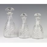 A pair of mallet shaped cut glass decanters with mushroom stoppers 20cm, a larger ditto 25cm The