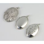 Three silver lockets