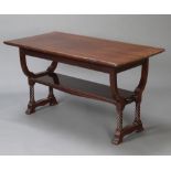 An Edwardian Art Nouveau rectangular mahogany library table with undertier, raised on spiral