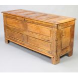 An 18th/19th Century inlaid oak settle of panelled construction with hinged lid 68cm h x 149cm w x