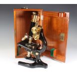 A Charles Perry students single draw pillar microscope no.5 7309 contained in a mahogany carrying