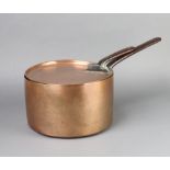 A 19th Century copper saucepan with polished steel handle 17cm x 28cm