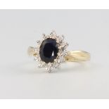 A 9ct yellow gold oval sapphire and diamond cluster ring, centre stone approx. 1.8ct diamonds 0.