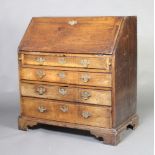 A Georgian country oak bureau, the fall front above 4 long drawers with brass swan neck drop