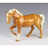 A Beswick figure of a stocky jogging mare, palomino gloss H855 modelled by Arthur Greddington 16cm