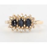 A 9ct yellow gold gem set triple cluster ring, 1.9 grams, size I