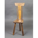 Ben Setter of Totnes, a carved oak spinning chair with solid seat raised on 3 turned supports