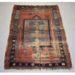 A blue and tan ground Caucasian rug, the centre medallion with a multi row border, 203cm x 139cm