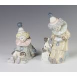 A Lladro figure of a seated clown playing a concertina 15cm, ditto of a seated clown with a dog on