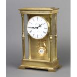 A German 9 day striking 4 glass clock with enamelled dial and Roman numerals contained in a gilt