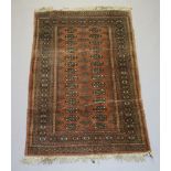 A pink and white ground Bokhara rug with 28 octagons to the centre within a multi row border 152cm x