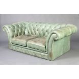 A 2 seat Chesterfield upholstered in green buttoned material 64cm h x 183cm w x 87cm d There is a