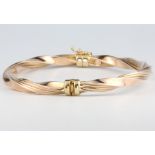 A 9ct yellow gold twist bangle, 7.4 grams