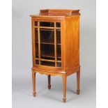 An Edwardian inlaid mahogany bow front display cabinet with 3/4 gallery, fitted shelves enclosed