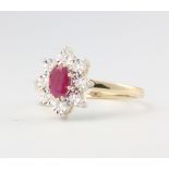 A 9ct yellow gold oval ruby and diamond cluster ring, the ruby approx. 0.57ct, diamonds 0.10ct, size