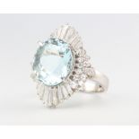 A platinum aquamarine and diamond cocktail ring, the centre stone 8.99ct the brilliant and tapered