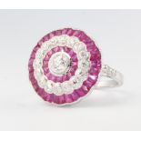 An Edwardian style platinum, ruby and diamond ring, the centre old cut diamond surrounded by