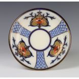 A MacIntyre & Co Burslem shallow dish decorated with stylised flower heads 23cm There is some