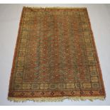 An orange ground machine made Bokhara style carpet with numerous octagons to the centre 230cm x