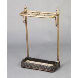 A Victorian gilt metal and iron 8 division stick/umbrella stand with gilt metal finials complete