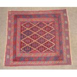 A red and blue ground Meshwani Gazak rug with diamond design to the centre within a multi row border