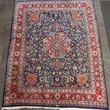 A red and blue ground Northwest Persian carpet with central medallion within a multirow border,