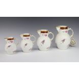 A set of 4 Coalport Caughley mask head graduated jugs decorated with flowers 18cm, 16cm, 14cm and